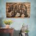 This is a large wood wall hanging featuring a bear and a forest scene. The artwork is wood burned by hand onto a pallet of reclaimed fence. 